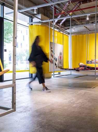 A women entering Studio 7 concept store surrounded by product displays.