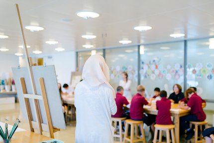 Instructor teaching children at a workshop