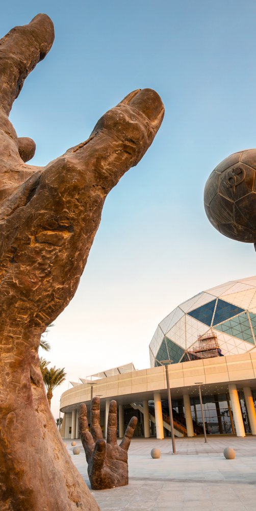 Lifesize installation showcasing bronze sculpted hands playing handball