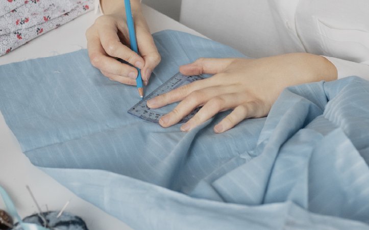 Kid hand designing cloths on fabric