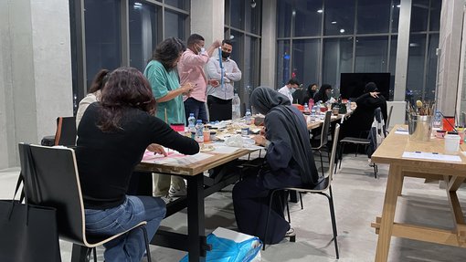 Participants in the workshop “Screen-printing Tote bags” at Fire Station working on their desks in the Education Studio.